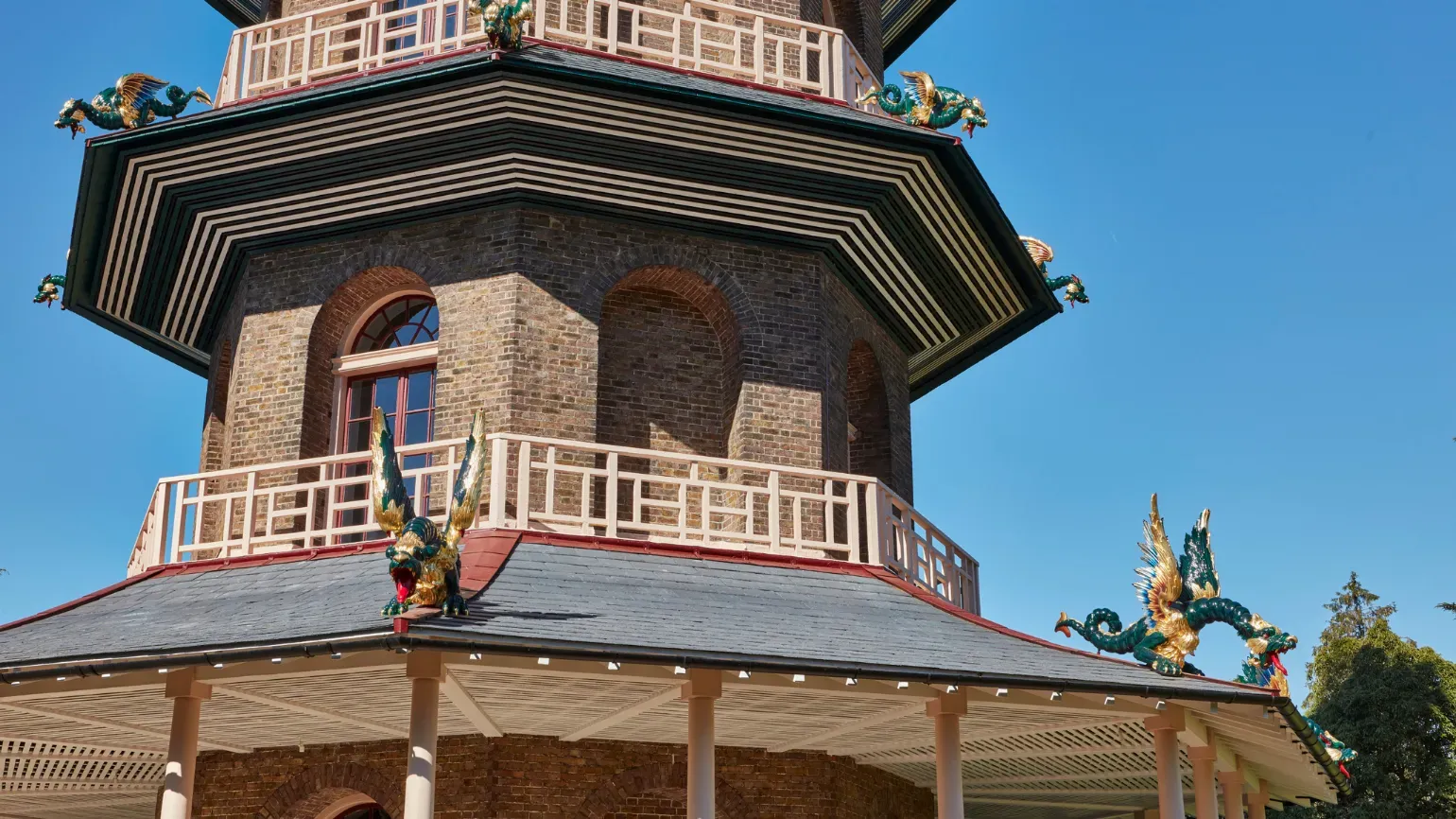Great Pagoda © Historic Royal Palaces Low angle shot of the Great Pagoda with a blue sky in the background. Dragons can be seen adorning the outside of the building.